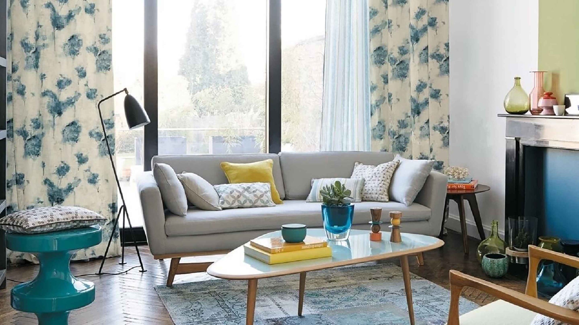 Modern living room with a gray sofa, coffee table, and decorative items.