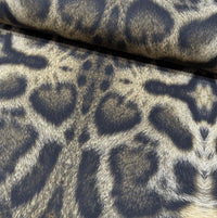 Large pattern leopard print upholstery curtain fabric in dark and light brown.