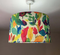 Colorful floral-patterned ceiling lampshade with lights on.
