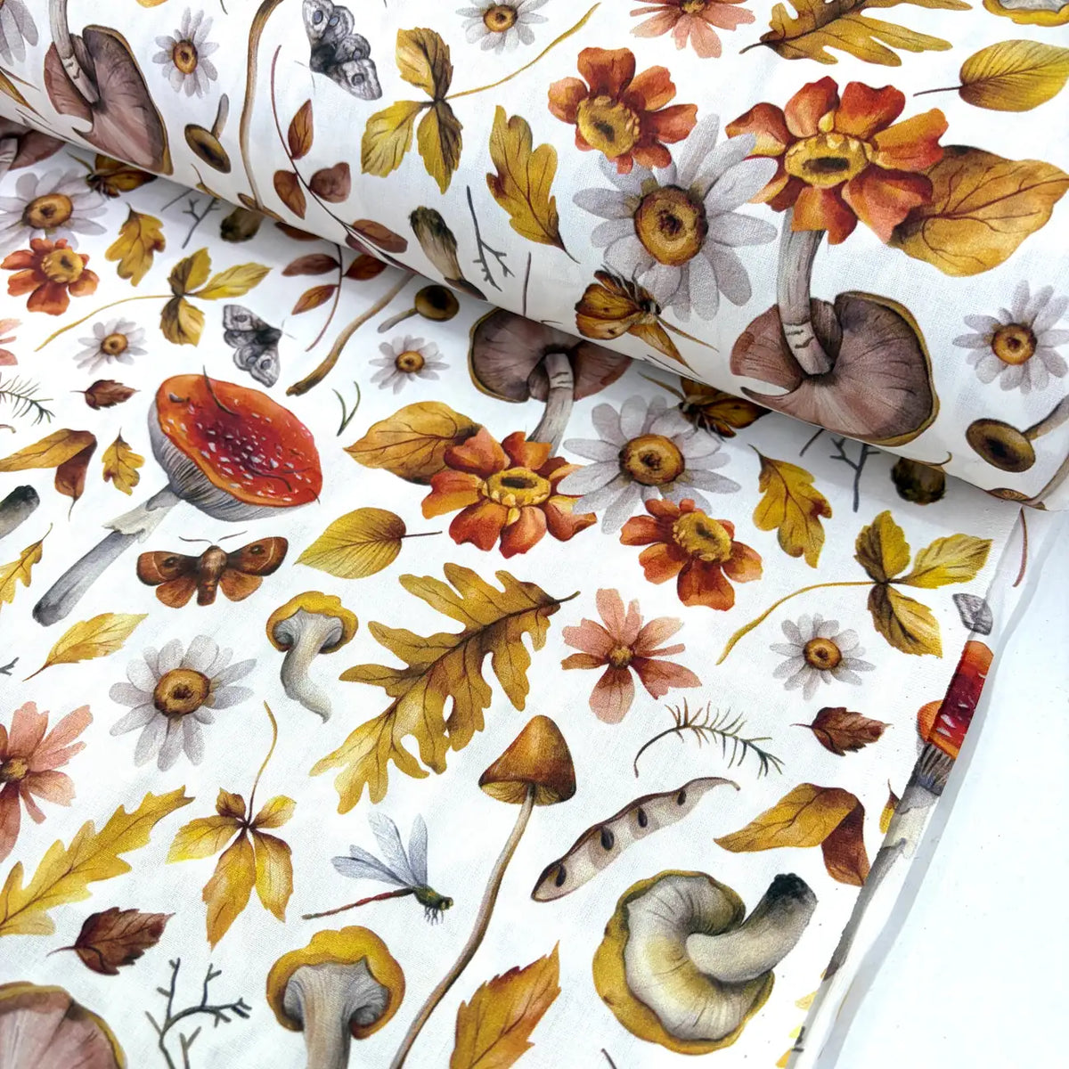 Watercolour autumn woodland cotton poplin fabric featuring mushrooms, wildflowers, oak leaves, butterflies and moths on a white background.