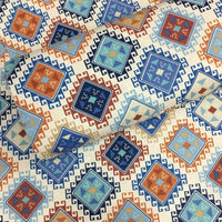Diamond patterned fabric with geometric square and triangle design in blue, orange, brown, red, navy and white.