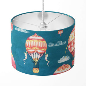 Teal blue lampshade with red and yellow hot air balloon design on a white background.