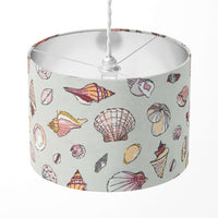 Silver grey lampshade patterned with blush pink sea shells.