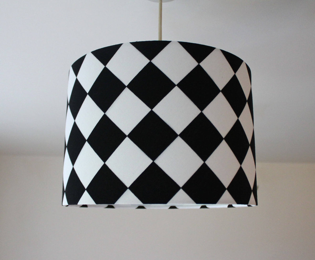 Black and white monochrome checkered ceiling lampshade on a plain background.
