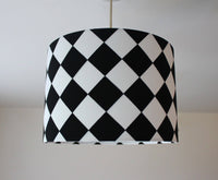 Black and white monochrome checkered ceiling lampshade on a plain background.