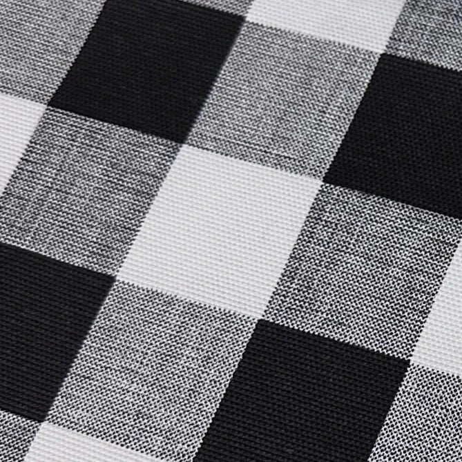 Close-up of a black and white check plaid print upholstery soft furnishing fabric