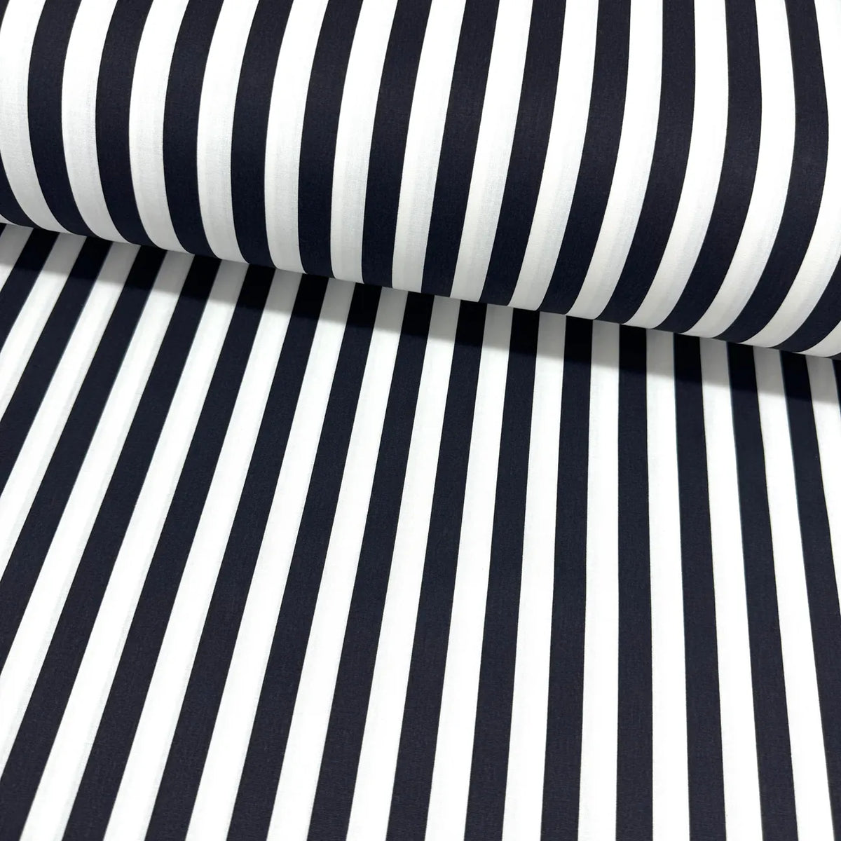 Black and white cotton stripe fabric with a classic vertical striped pattern, ideal for quilting, dressmaking, patchwork, crafts and home décor.