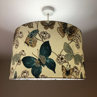 Decorative lampshade with tropical butterflies and flowers pattern on a plain background.