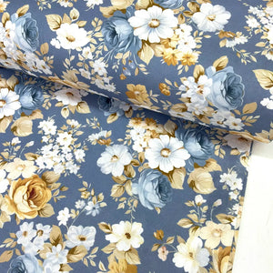 Blue floral cotton poplin fabric featuring white flowers, blue roses and botanical foliage on an indigo blue background.