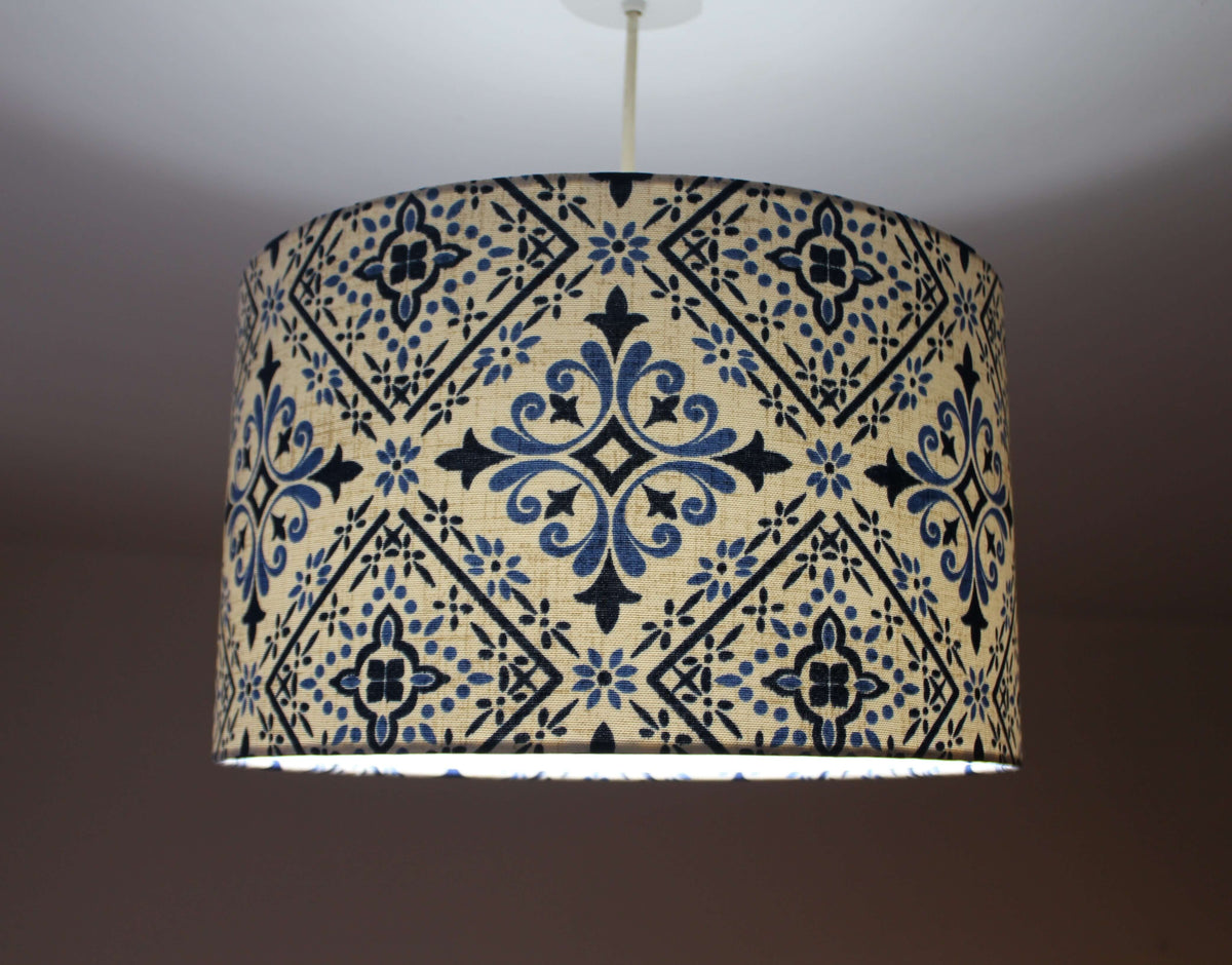 Moroccan tile lampshade with blue and navy pattern on a plain background.
