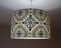 Moroccan tile lampshade with blue and navy pattern on a plain background.