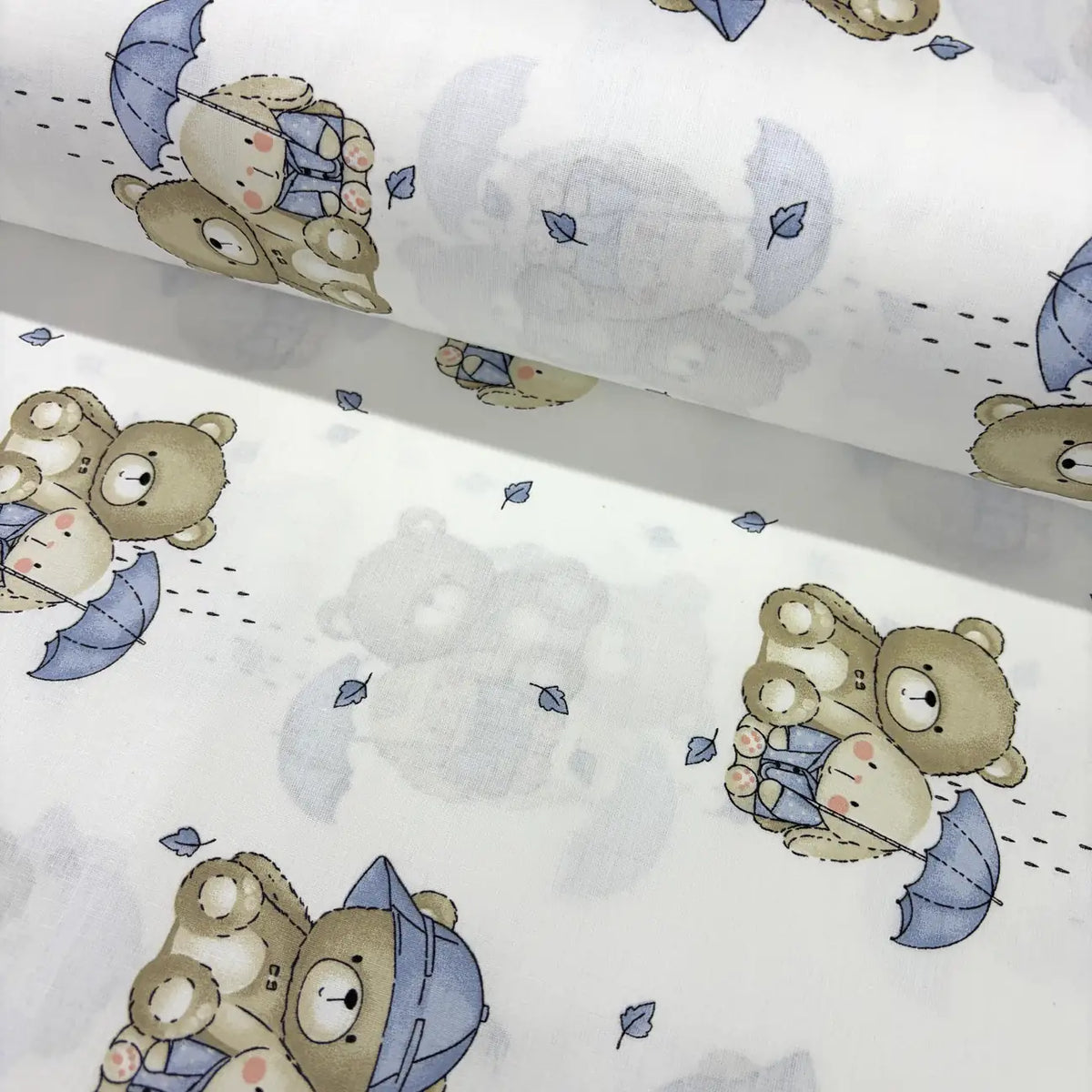 Cotton poplin fabric patterned with blue beige teddy bear, bunny and umbrella on a white background. 