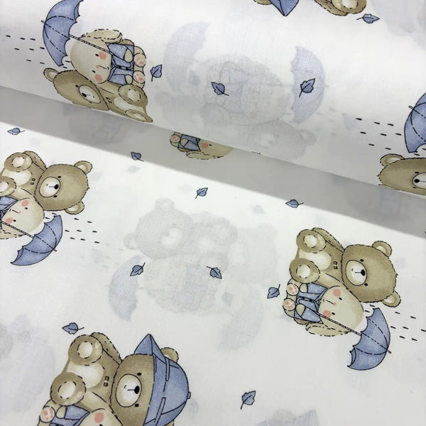 Cotton poplin fabric patterned with blue beige teddy bear, bunny and umbrella on a white background. 