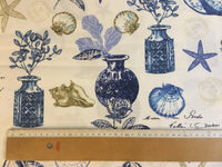 Nautical-themed fabric with blue vases, shells, and plants on a white background.
