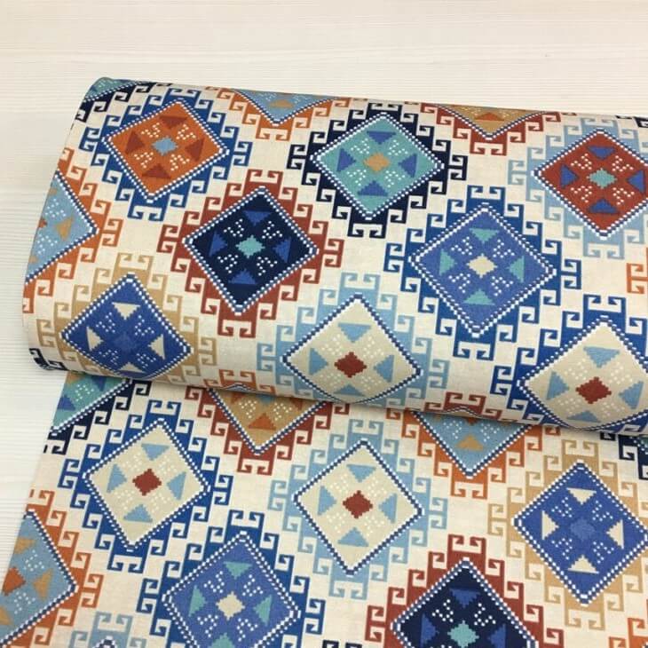 Roll of fabric with geometric pattern on a white background.