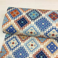 Roll of fabric with geometric pattern on a white background.