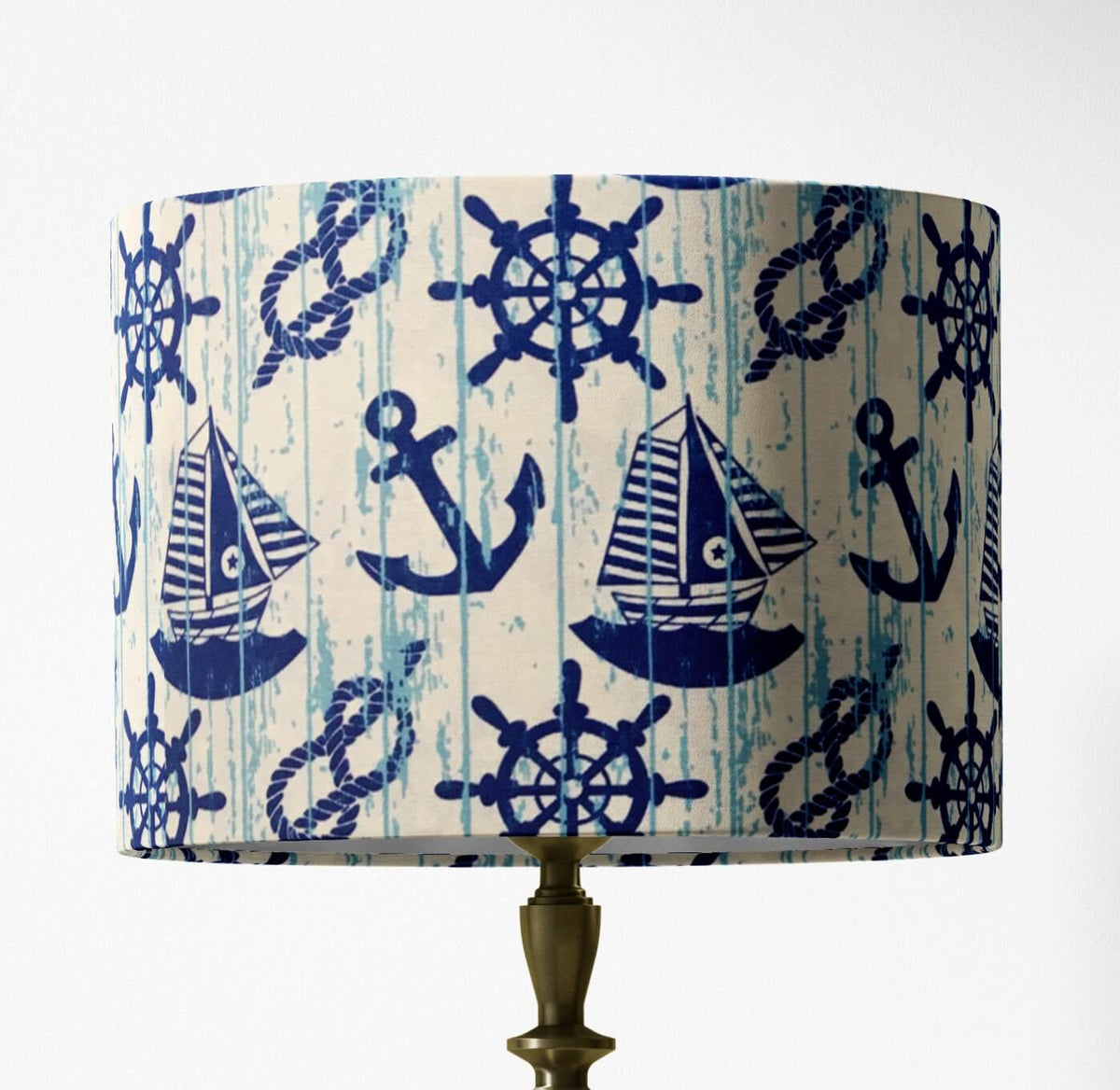 Table lampshade with nautical pattern featuring anchors, ropes, boats and wheels on a white background.