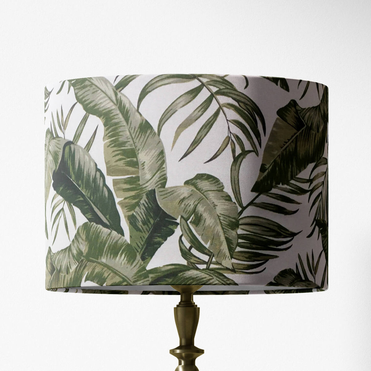 Lampshade with botanical sage green leaf pattern on a white background.