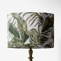 Lampshade with botanical sage green leaf pattern on a white background.