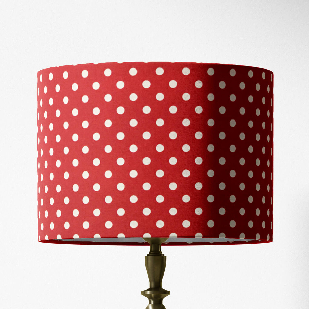 A red polka dot lampshade designed for table lamps, floor lamps, or ceiling pendants.