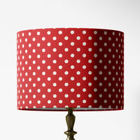 A red polka dot lampshade designed for table lamps, floor lamps, or ceiling pendants.