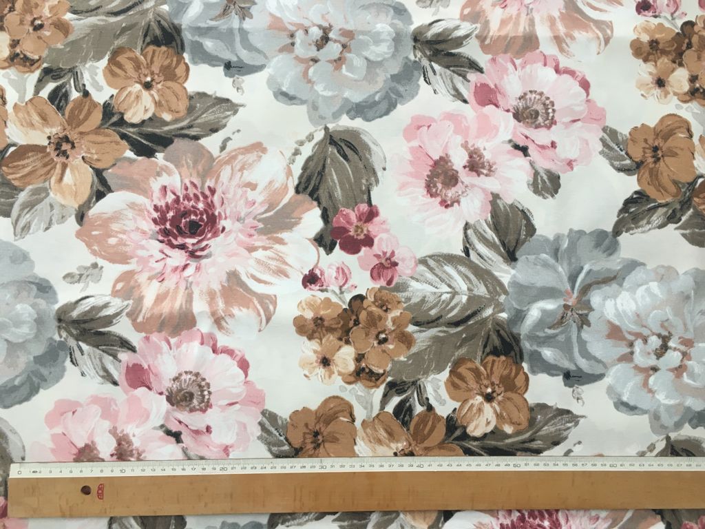 Floral fabric pattern with a ruler for scale on a white background.