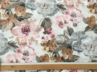 Floral fabric pattern with a ruler for scale on a white background.
