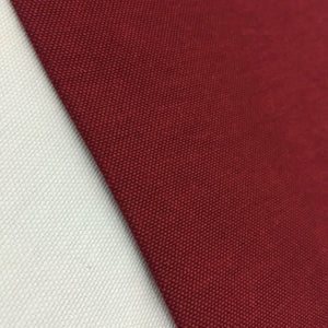 Burgundy cotton canvas fabric with a plain woven texture, ideal for upholstery, curtains, cushions, bags, crafts, and soft furnishing projects.