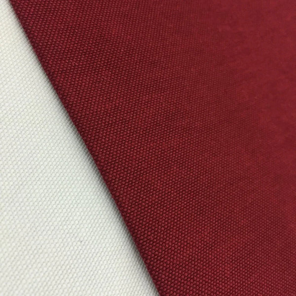 Burgundy cotton canvas fabric with a plain woven texture, ideal for upholstery, curtains, cushions, bags, crafts, and soft furnishing projects.