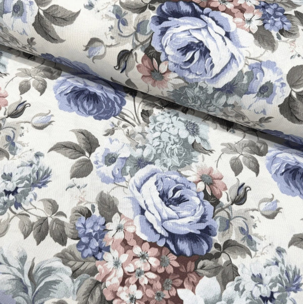 Pastel floral fabric with blue cabbage roses and pink hydrangea flowers on a white background.
