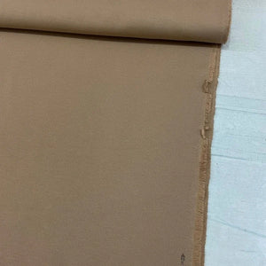 Camel brown cotton canvas upholstery fabric with a plain woven texture, ideal for curtains, cushions, chairs, sofas, furniture and outdoor projects.