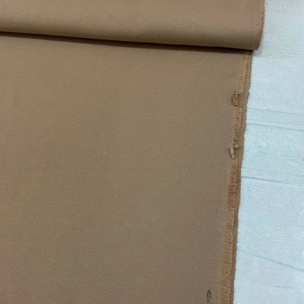 Camel brown cotton canvas upholstery fabric with a plain woven texture, ideal for curtains, cushions, chairs, sofas, furniture and outdoor projects.