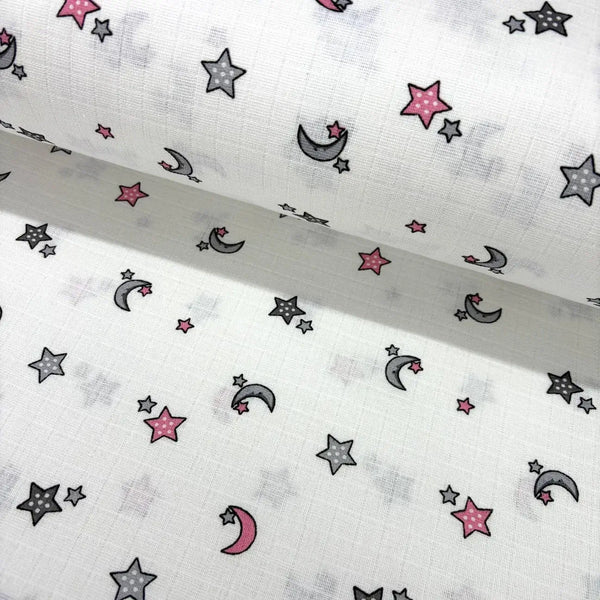 Pink and grey stars and moons patterned celestial cotton muslin fabric.