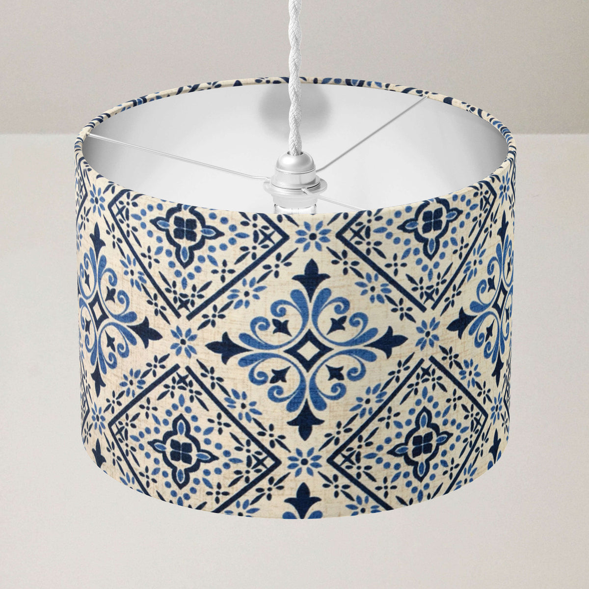 Ceiling lampshade with blue and white geometric pattern on a plain background.