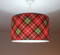 Red and green plaid lampshade on a plain background