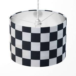 A black and white checkered drum lampshade.