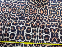 Brown leopard print upholstery fabric with a measuring tape at the bottom.