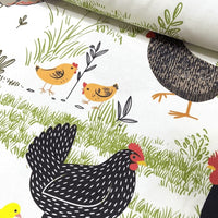 Upholstery fabric with chicken, hen, rooster and chick pattern on a white background. 