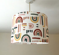 Rainbow ceiling pendant lampshade in red, yellow, pink, green and white.