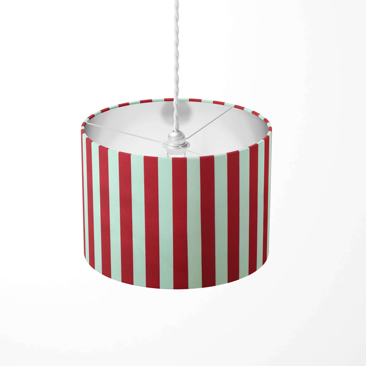 Red circus striped ceiling lampshade with red and white stripes on a white background.