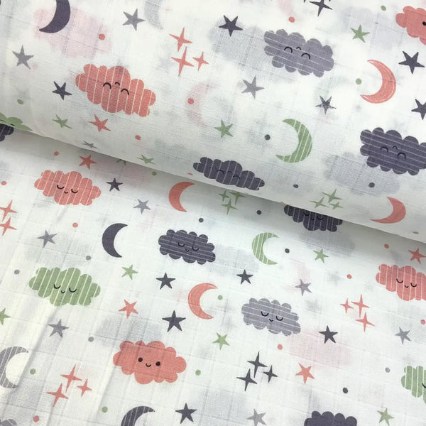 Clouds and moon printed 100% cotton muslin fabric in pastel tones.