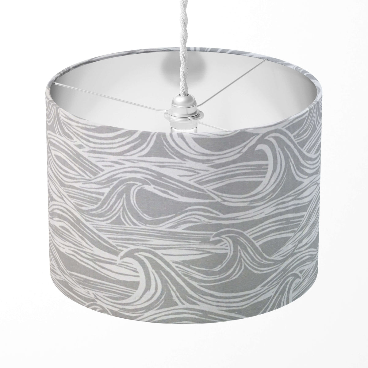Grey and white wave patterned lampshade on a white background.