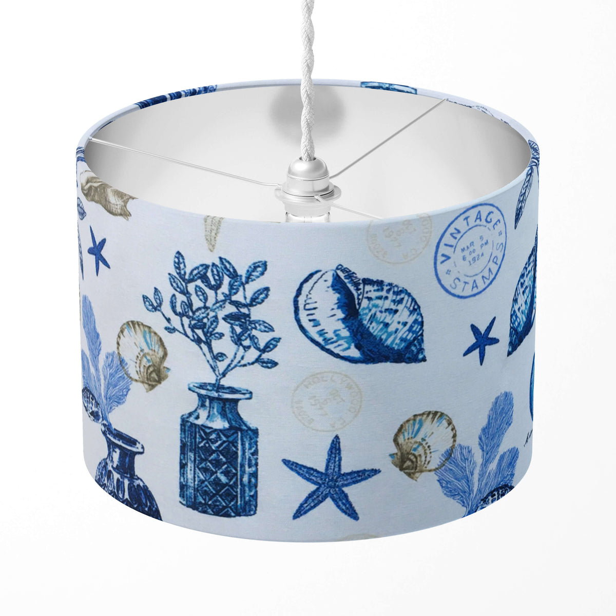 Lampshade with blue and white vintage nautical pattern on a white background.
