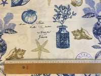 Fabric with nautical-themed design featuring shells, plants, and a ruler for scale.