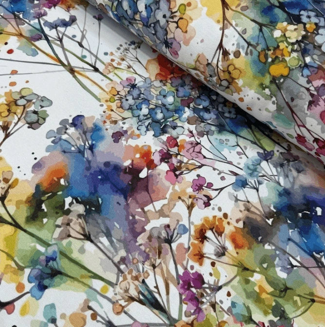 Colorful floral patterned fabric with watercolor style on a white background.
