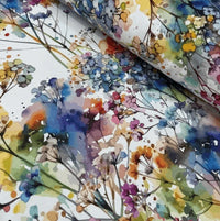 Colorful floral patterned fabric with watercolor style on a white background.
