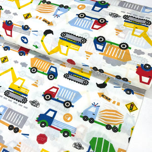Construction vehicles cotton fabric featuring colourful diggers, dump trucks, excavators, lorries and roadwork signs on a white background.