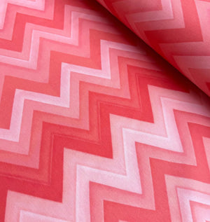 Retro chevron pattern upholstery fabric in pink and red.