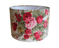 Red floral patterned lampshade on a white background.