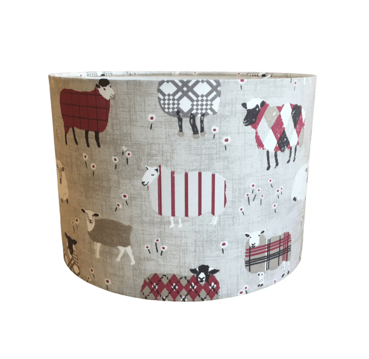 Grey and red fabric handmade lampshade with farm animal pattern on a white background.